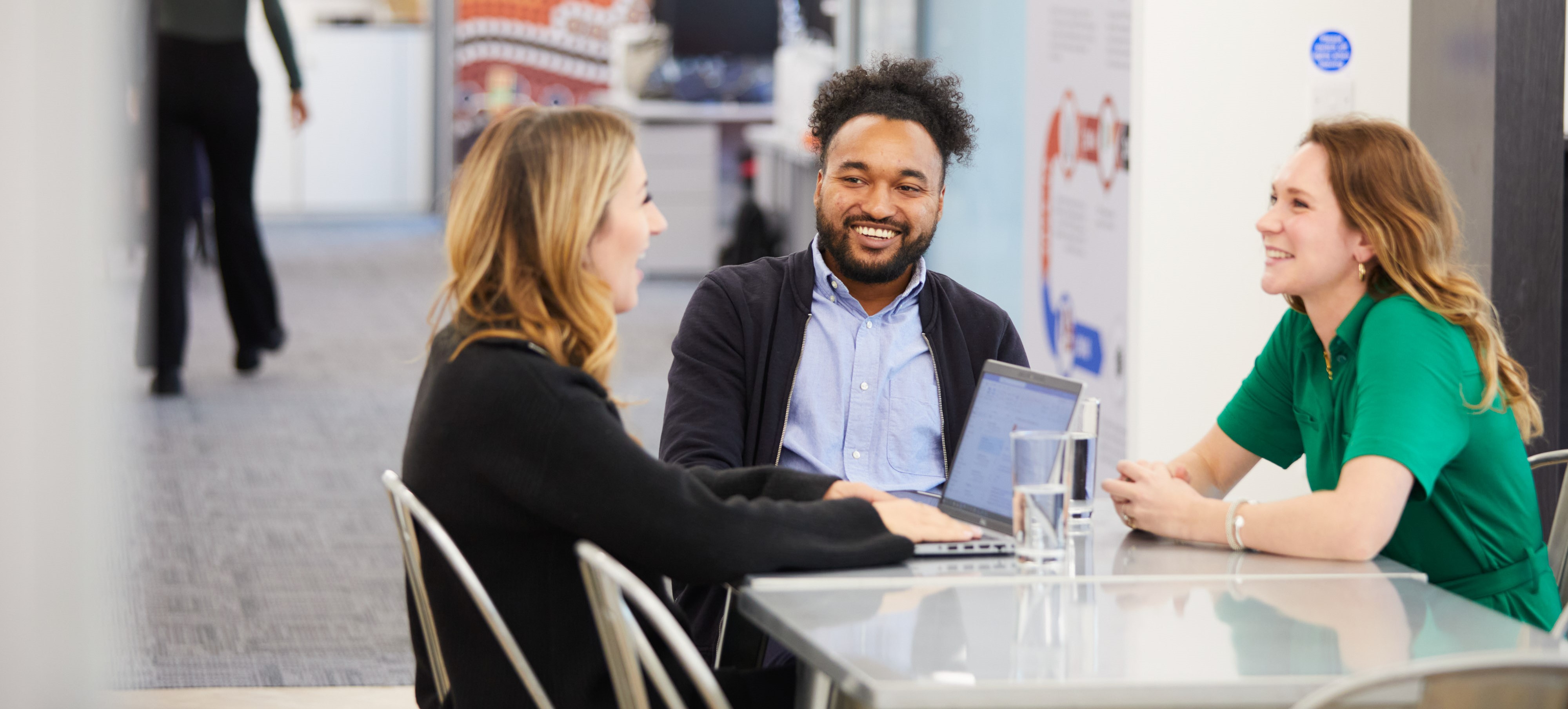 People smiling around desk Flight Centre Travel Group